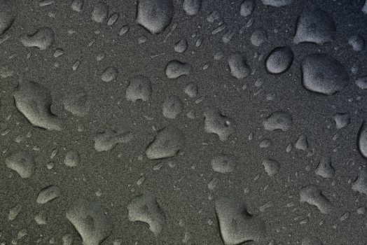 Fresh raw chicken fillet on a wooden cutting board.Water droplets on black background.