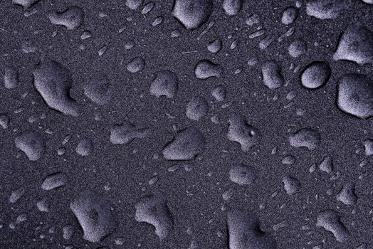 Fresh raw chicken fillet on a wooden cutting board.Water droplets on black background.