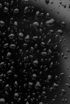 Fresh raw chicken fillet on a wooden cutting board.Water droplets on black background.