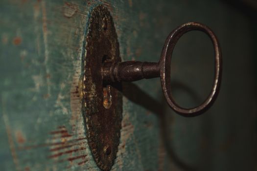An old rusty key in a keyhole