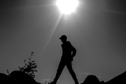 Male silhouette walking in natural backlight