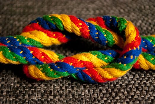 A rainbow colored rope tied into a knot