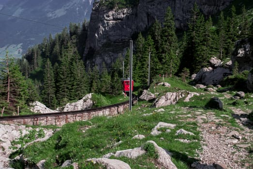A red train going up the mountain