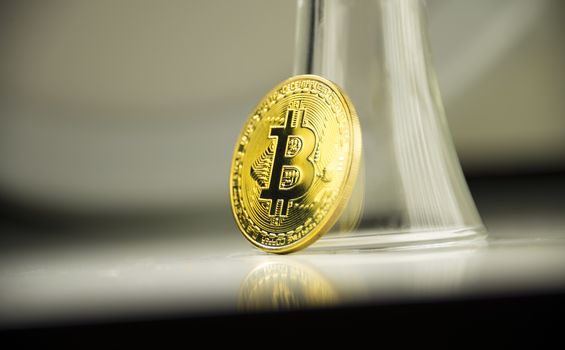 Gold coin cryptocurrency Bitcoin stands on the edge.
