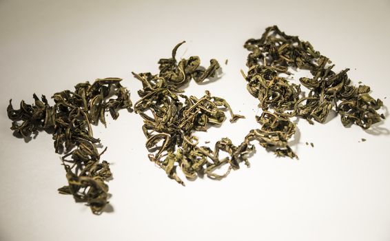 inscription tea from green tea leaves on a white background.