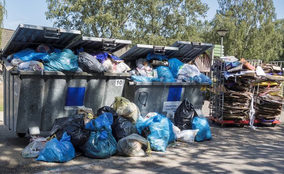 garbage containers that are full of garbage and junk because the collection service strikes and the bins do not empty