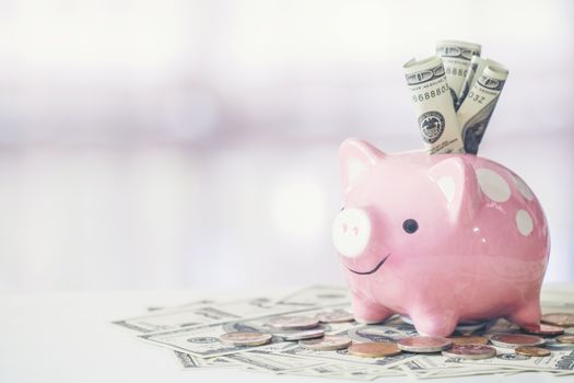 pink color piggy bank on white table, saving concept