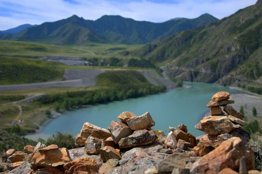 Socral pyramids on top of a mountain overlooking the valley and mountains. Katun River, Altai, Russia.