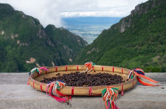 Drying coffee on a bamboo tray in a mountain atmosphere