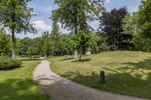 big english garden with green grass and path for walking