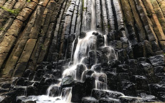 landscape of Basaltic prism formation in a central part of Mexico with a waterfall
