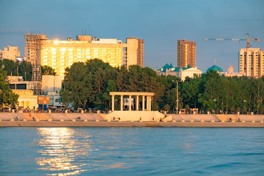 View of the city of Khabarovsk from the Amur river. Urban landscape in the evening at sunset