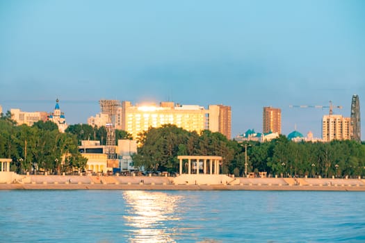 View of the city of Khabarovsk from the Amur river. Urban landscape in the evening at sunset