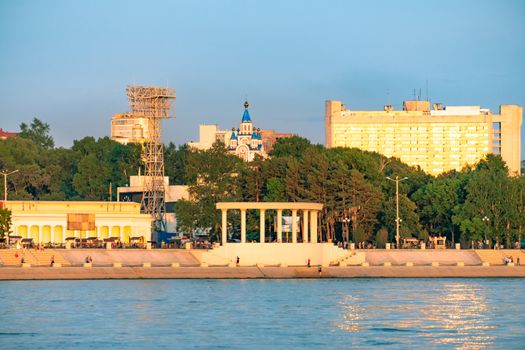 View of the city of Khabarovsk from the Amur river. Urban landscape in the evening at sunset
