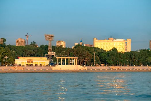 View of the city of Khabarovsk from the Amur river. Urban landscape in the evening at sunset