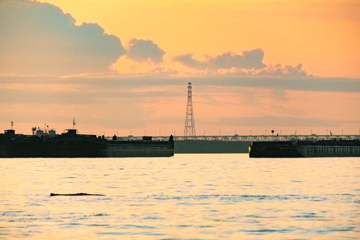 View of the city of Khabarovsk from the Amur river. Urban landscape in the evening at sunset