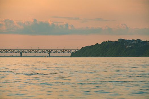 View of the city of Khabarovsk from the Amur river. Urban landscape in the evening at sunset