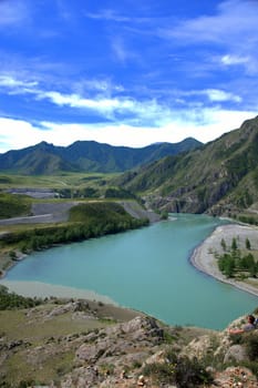 The bend of the turquoise mountain river in the hollow of high hills. Katun, Altai, Siberia, Russia.