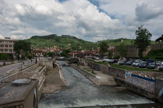 Novi Pazar, Serbia - May 5, 2018: City center with river and fortress ruin.  Novi Pazar, town of southern Serbia.
