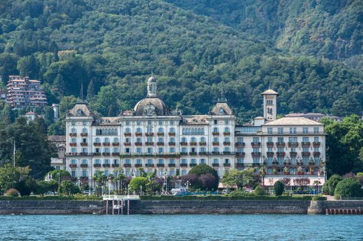 Stresa,Lake Maggiore,Italy-August 30,2018 : Grand Hotel Des Iles Borromees and Stresa town embankment, view from lake.