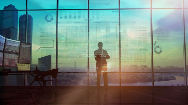 In an office with large windows, there is a silhouette of a trader looking at an infographic showing the exchange area and trading data.