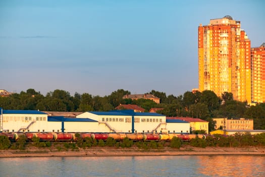 View of the city of Khabarovsk from the Amur river. Urban landscape in the evening at sunset