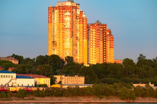 View of the city of Khabarovsk from the Amur river. Urban landscape in the evening at sunset