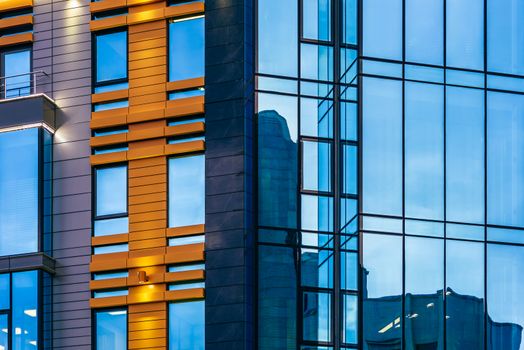 Modern high-rise office building with a glass facade, background.