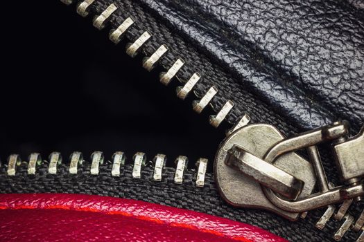 Close up stainless zipper in backpack leather. Concept of clothes or fashion.