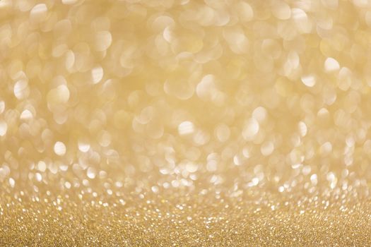 Abstract shining glitters golden holiday bokeh background with copy space for text