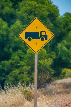 Caution road trains ahead street sign