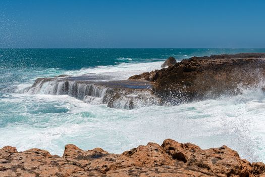 Rough coast line wave spray at Quobba Blow Holes in Western Australia