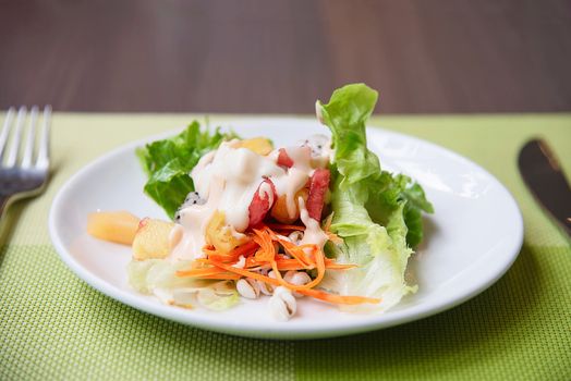 Fresh vegetable healthy salad on white plate ready for eating - fresh healthy food concept
