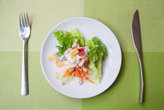 Fresh vegetable healthy salad on white plate ready for eating - fresh healthy food concept