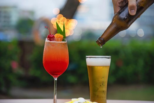 People celebration in restaurant with beer and mai tai or mai thai - happy lifestyle people with happy drink in garden concept