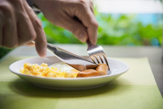 Business man eat the American breakfast set in a hotel - people take a breakfast in hotel concept