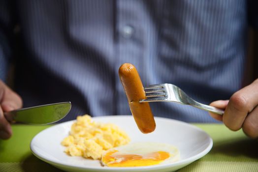 Business man eat the American breakfast set in a hotel - people take a breakfast in hotel concept