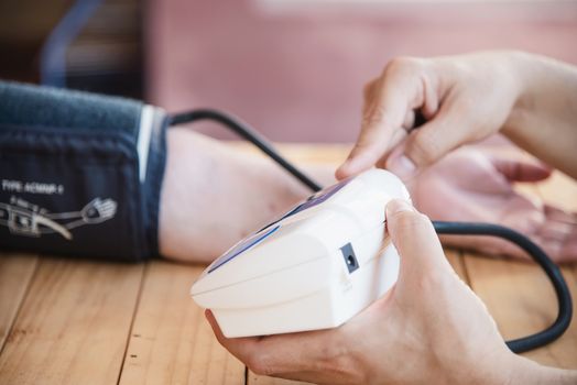 Old lady is being checked blood pressure using blood pressure monitor kid set - people with health care medical instrument set concept