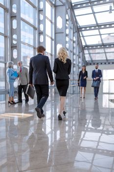 Business people walking in the lobby of a modern business center