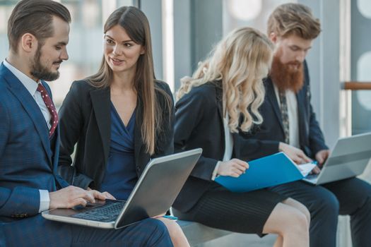 Business people working with documents on laptops at break