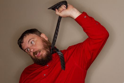 man hanging himself with his tie while at work