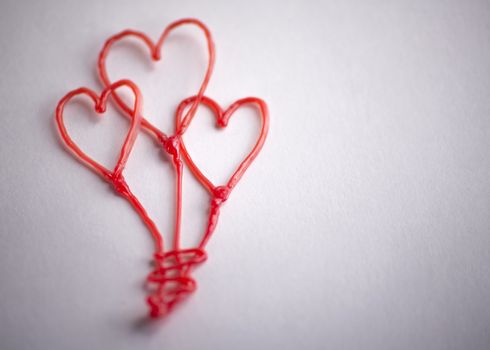 red heart drawn by 3d pen on white background
