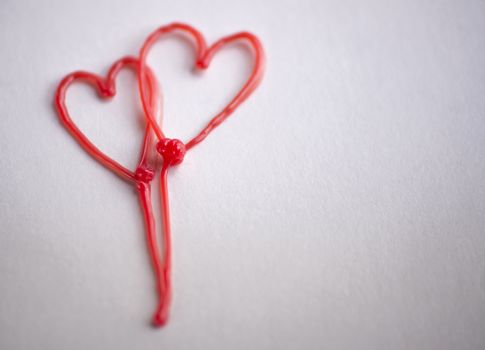 red heart drawn by 3d pen on white background