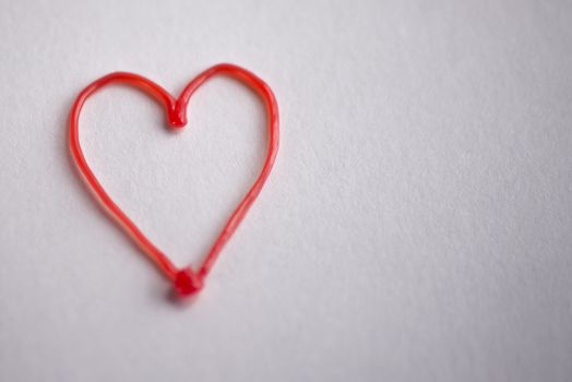 red heart drawn by 3d pen on white background