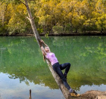 Leaning back on casuarina tree arching out over the remote bushland