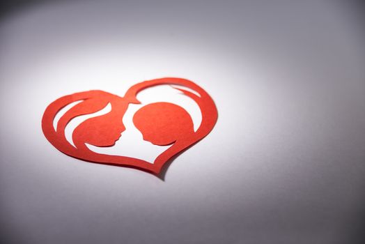 mother and child in the form of hearts from paper.