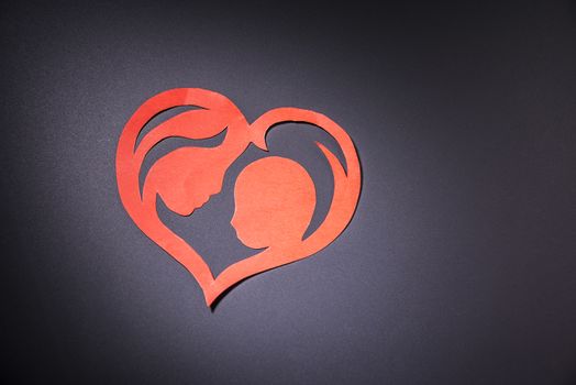 mother and child in the form of hearts from paper.