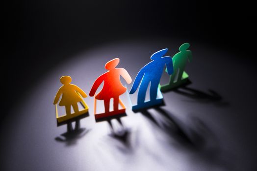 the family of colored paper on a dark background