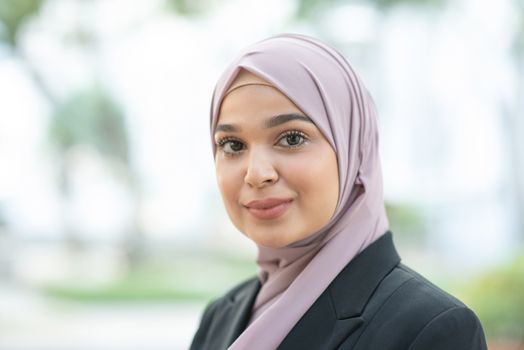 Portrait of Muslim woman in business suit, smile and looking at camera.