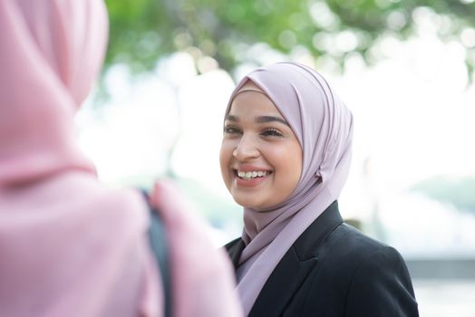 Beautiful Muslim business woman talking and smile.